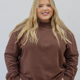 Model in espresso mock neck in 2xl