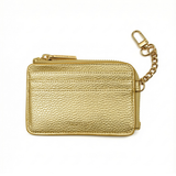 Back view of gold On-the-Go needlepoint wallet featuring exterior card slots, textured metallic finish, and coordinating gold clip-on chain.