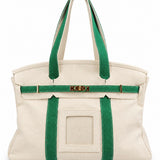Parker self-finishing needlepoint canvas boat tote in green with cream canvas exterior, gold hardware, and front needlepoint insert.
