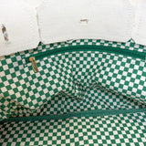 Interior view of the Parker needlepoint canvas tote featuring green and white gingham lining and a coordinating interior zippered pocket.