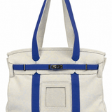 Parker self-finishing needlepoint canvas boat tote in navy blue with cream canvas, gold hardware, and front needlepoint insert.