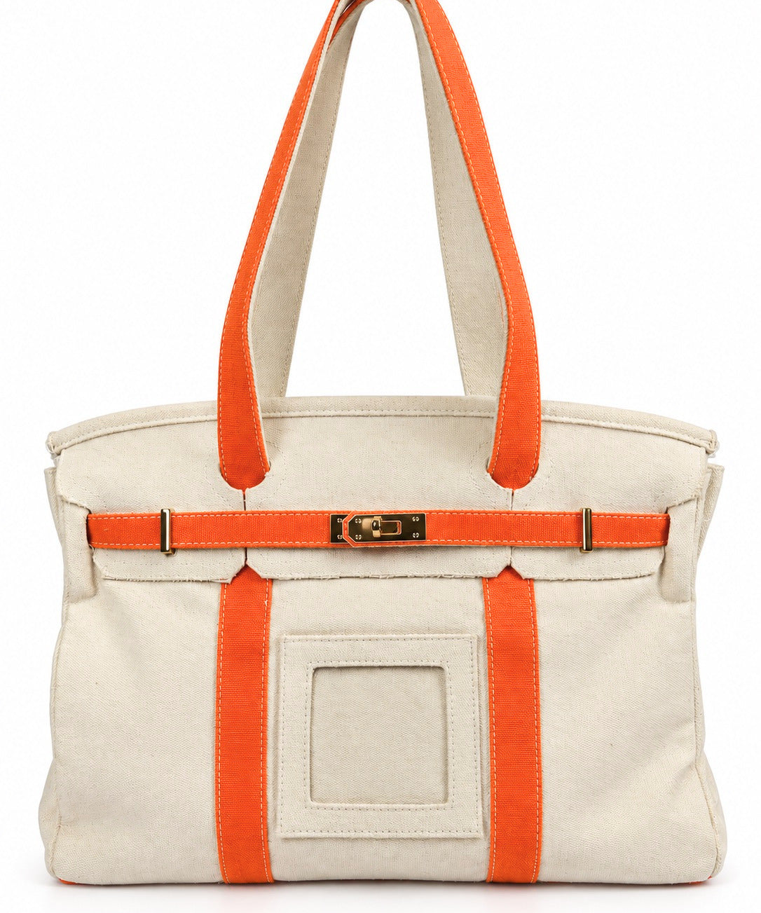 Parker self-finishing needlepoint boat tote bag with bright orange straps, cream canvas exterior, gold hardware, and front insert.