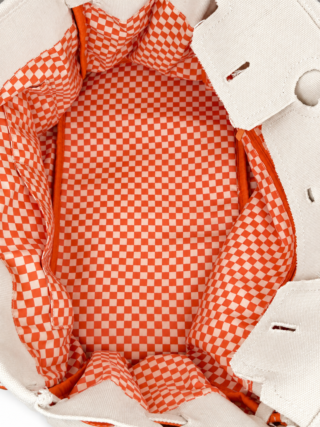 Interior view of the Parker canvas needlepoint tote featuring orange and white gingham lining and spacious storage.
