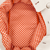 Interior view of the Parker canvas needlepoint tote featuring orange and white gingham lining and spacious storage.
