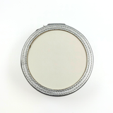 Top view of silver self-finishing needlepoint jewelry case showing the round insert frame designed for needlepoint personalization.
