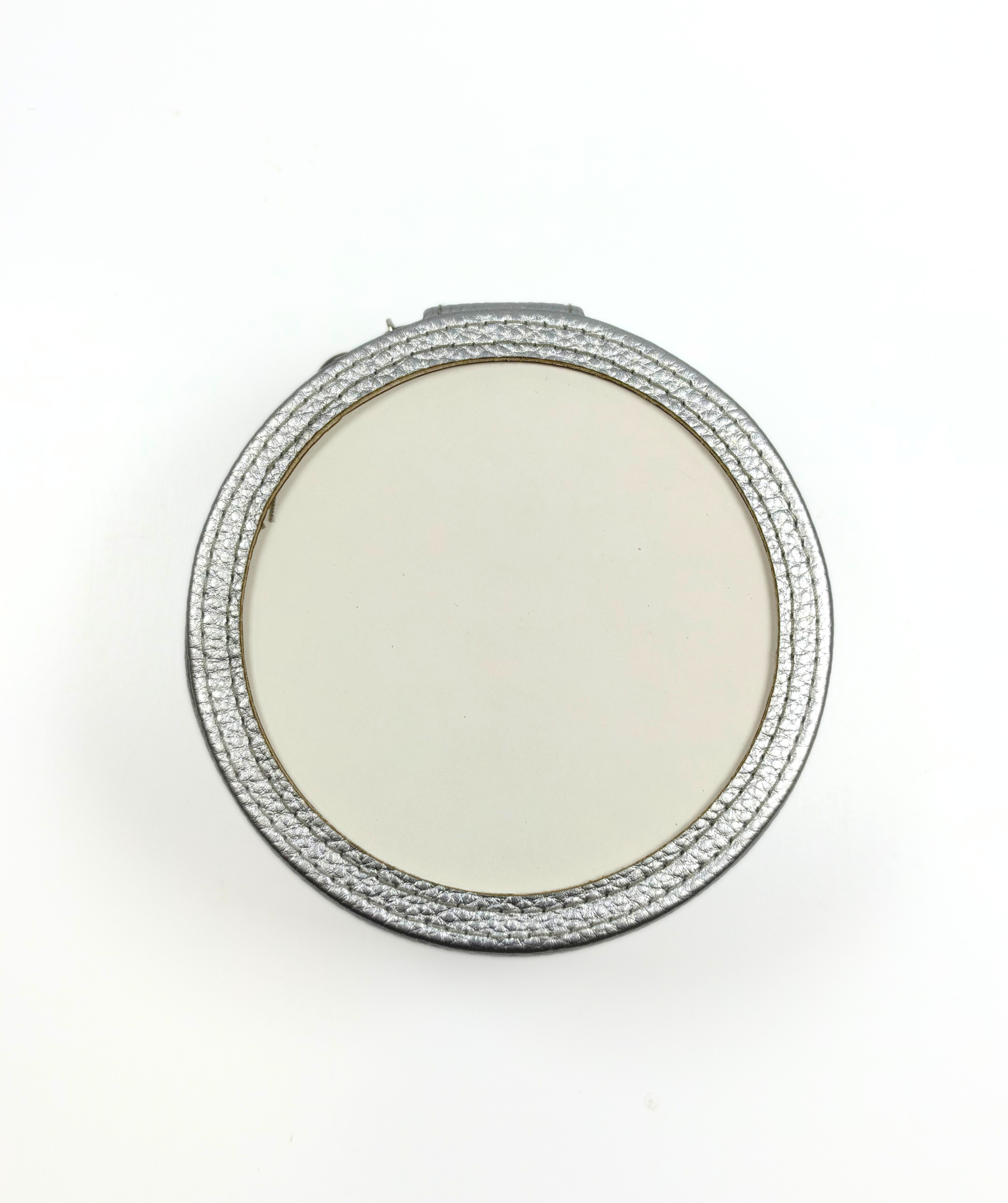 Top view of silver self-finishing needlepoint jewelry case showing the round insert frame designed for needlepoint personalization.