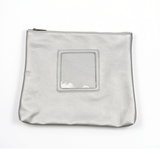 Silver metallic self-finishing needlepoint travel case with a zippered closure and square front window designed for needlepoint personalization.