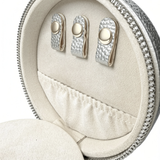 Inside view of silver self-finishing needlepoint travel jewelry case featuring earring holders, soft fabric lining, and an interior storage pocket.
