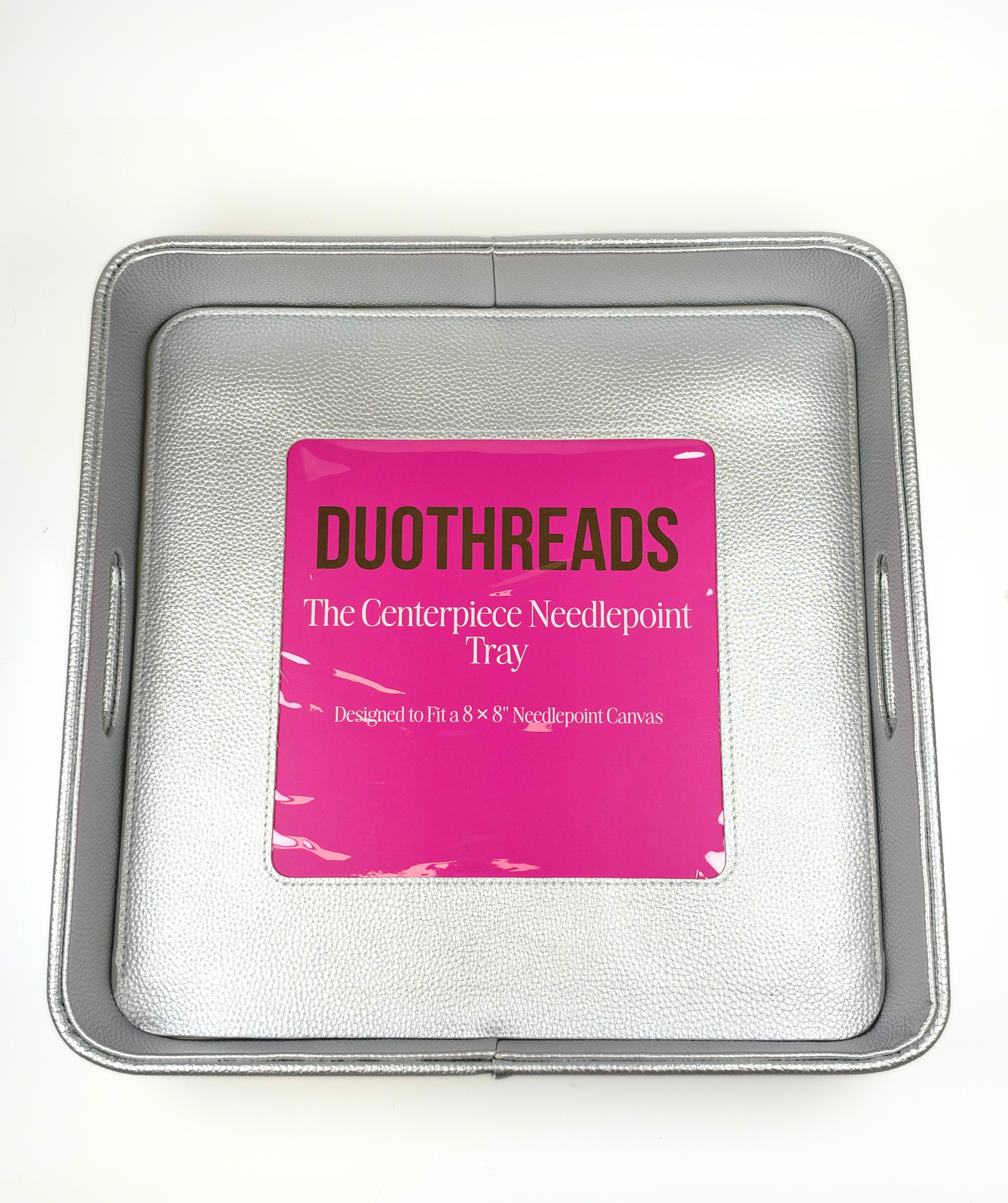 Silver metallic self-finishing needlepoint valet tray featuring a square needlepoint insert window, raised edges, and textured interior.